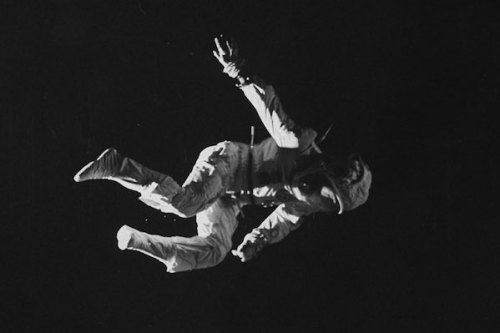 A trampolinist in a space suit imitating