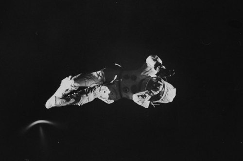 A trampolinist in a space suit imitating