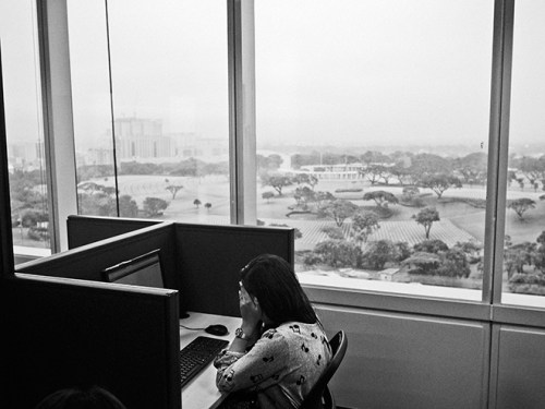Manila, Philippines. August 28, 2014. An employee working as a content moderator for Task Us sits in front of her computer at her cubicle on the 11th floor of the SM Aura Office Building Tower in the Taguig district of Manila. Task Us is an American outsourcing tech company with offices in the Philippines. (Photo by Moises Saman/MAGNUM)